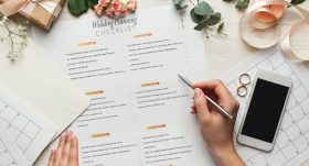 En person planlegger bryllup ved hjelp av en sjekkliste og kalender på et skrivebord.